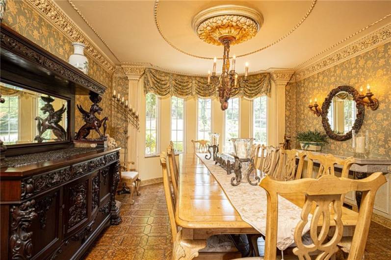 Table for 12! No problem in this spacious and elegant dining room. Artisan plaster moldings throughout the room that were hand carved and placed.