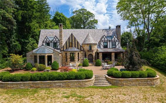 Welcome to this beautiful French Country Normandy stone and Tudor home nestled in the suburbs.