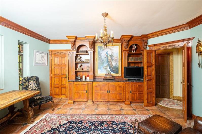 What a study this is with thick molding and lions heads in the bookcases.
