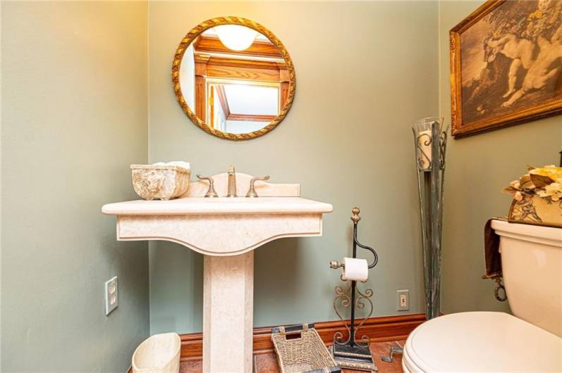 Lovely half bath off of study on main floor with gorgeous stone pedestal sink.