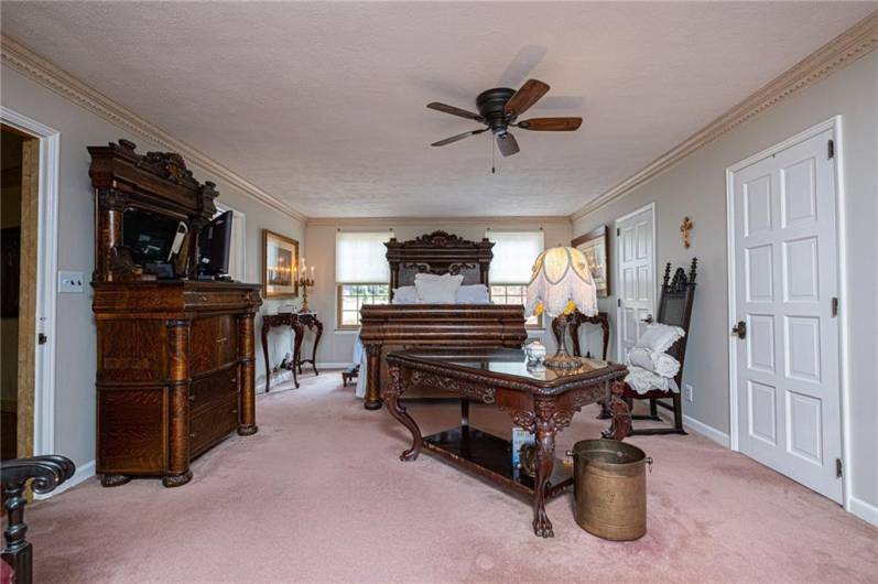 This wonderful stately primary bedroom is all the space you could want. Beautiful moldings and brightness make this room special.
