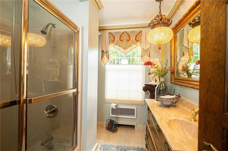 Another amazing antique chandelier in this family bathroom.