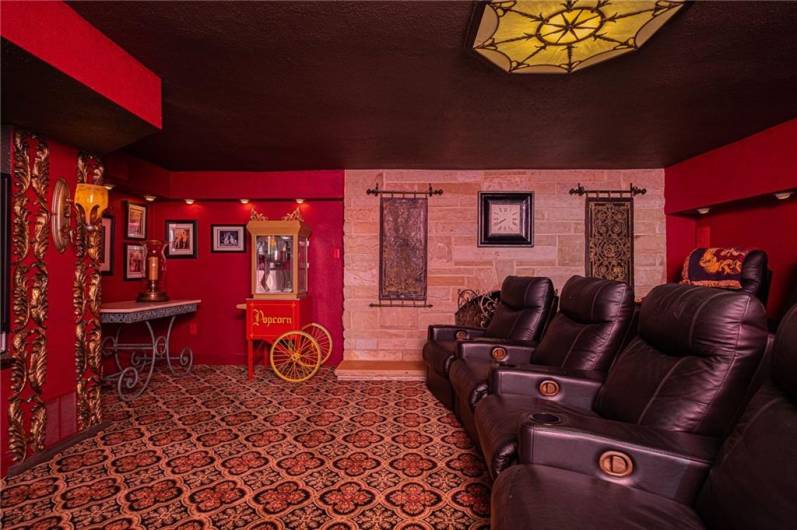 There it is. The 6th and final fireplace in the amazing theater room in the game room. Classy and comfortable stadium seating. Plenty of room for snacks which always go with a movie night.