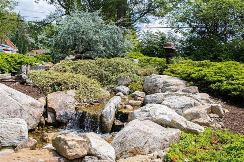 This amazing waterfall which splits the governors drive in the back is only but a small part of the amazing landscaping throughout this yard. The sound of water is always soothing and lovely.