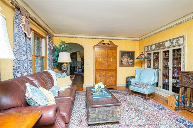 Owners installed this beautiful antique cabinet as a fixture into the wall of the family room for your most special things. Along with adding the extensive crown molding.