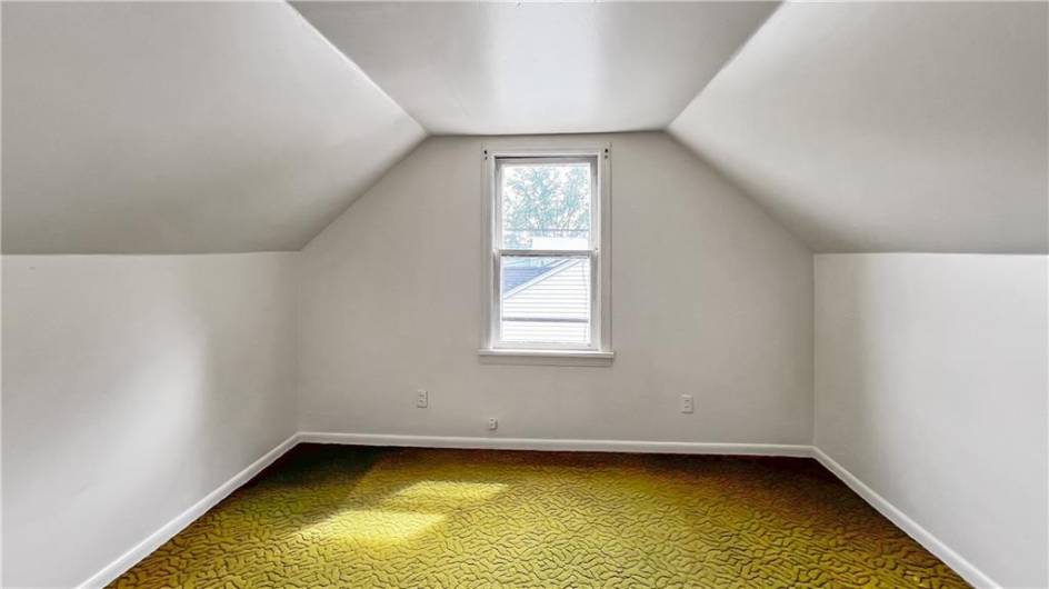 A large room upstairs that could be used as a bedroom.