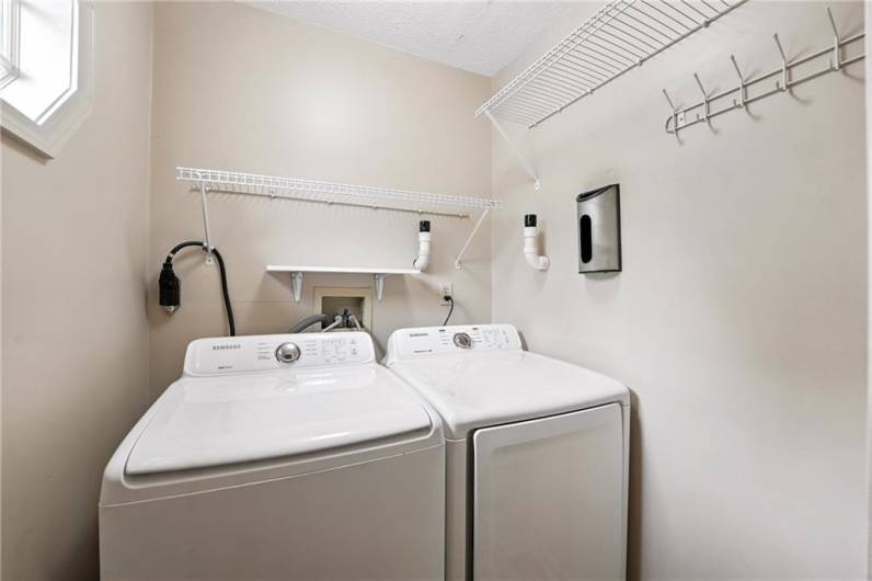 Laundry is located off the kitchen. Both are included in the sale.