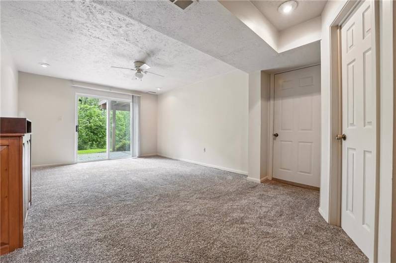 This finished room is located in the basement area and offers access to the lower-level patio.