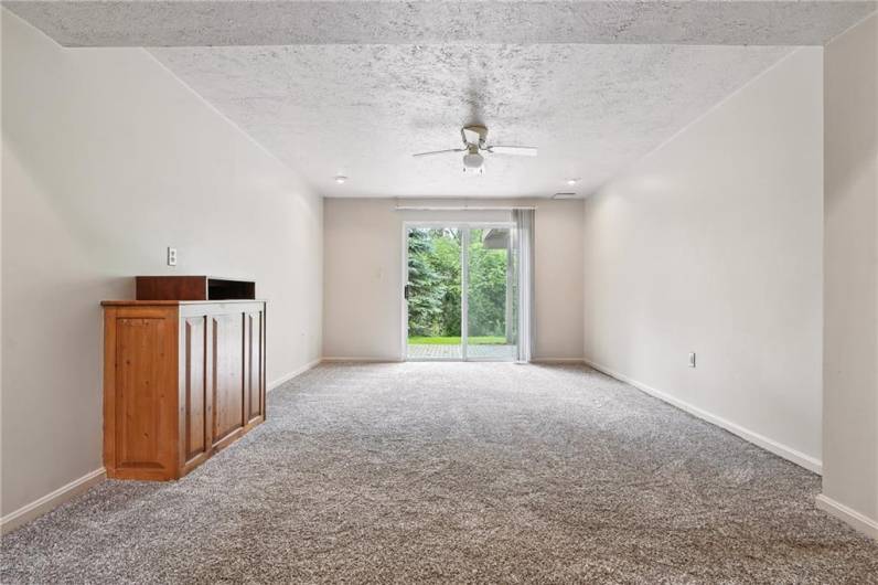This finished room is located in the basement area and offers access to the lower-level patio. Seller would like to leave the stand for the new owner.