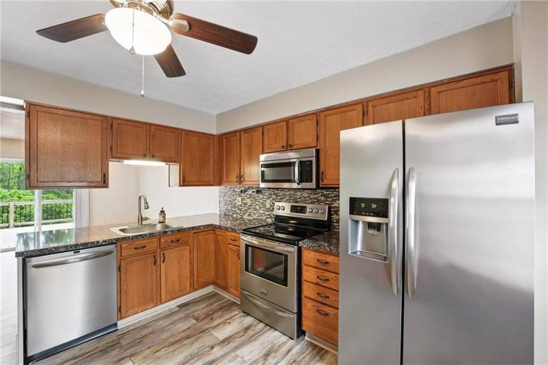 Beautiful kitchen with refrigerator, stove, microwave and dishwasher included in the sale. Flooring was updated in 2020.