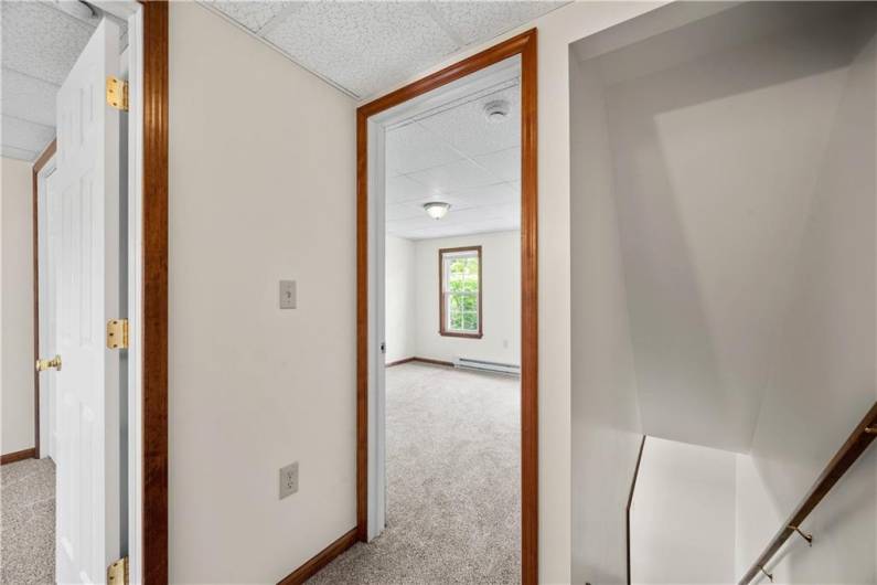 top of steps, view into to both bedrooms. New carpeting.