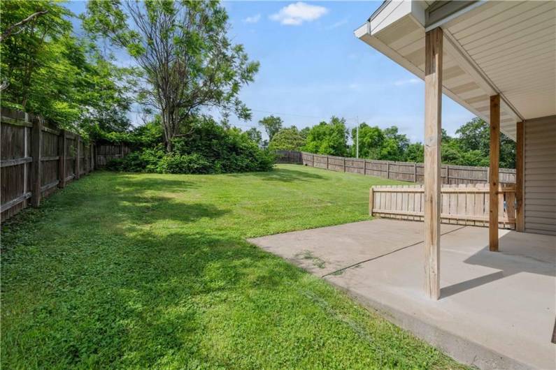 Covered patio with view of backyard.  Fence provides privacy.