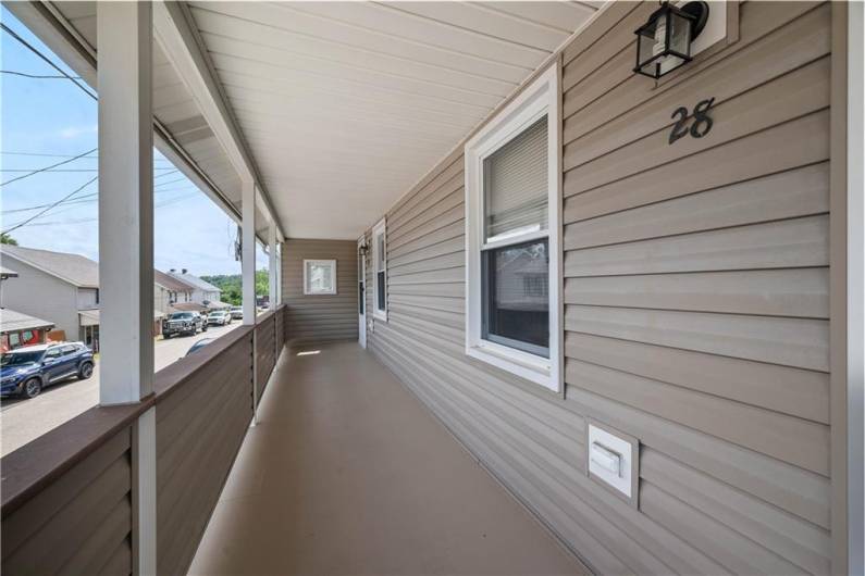 Welcoming covered porch, well maintained.