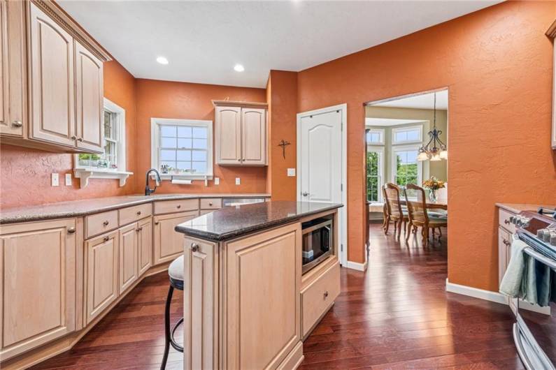 This beautiful kitchen- the heart of a home, has quartz countertops, stainless appliances, a large panty, pull out spice rack and more!
