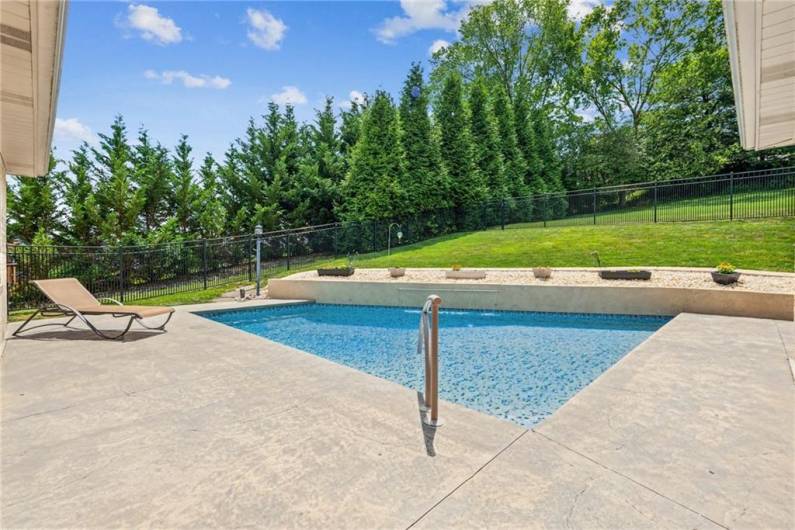 Enjoy the ultimate outdoor escape with a beautifully designed in-ground pool, complete with a cascading waterfall that adds both beauty and serenity.Enjoy the ultimate outdoor escape with a beautifully designed in-ground pool, complete with a cascading waterfall that adds both beauty and serenity.”