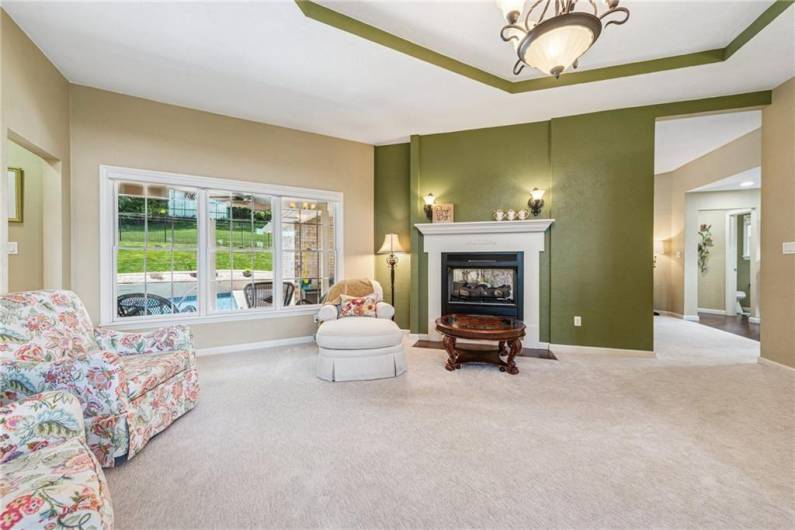See through gas fireplace, tray ceilings, lots of natural sunlight overlooking the pool!