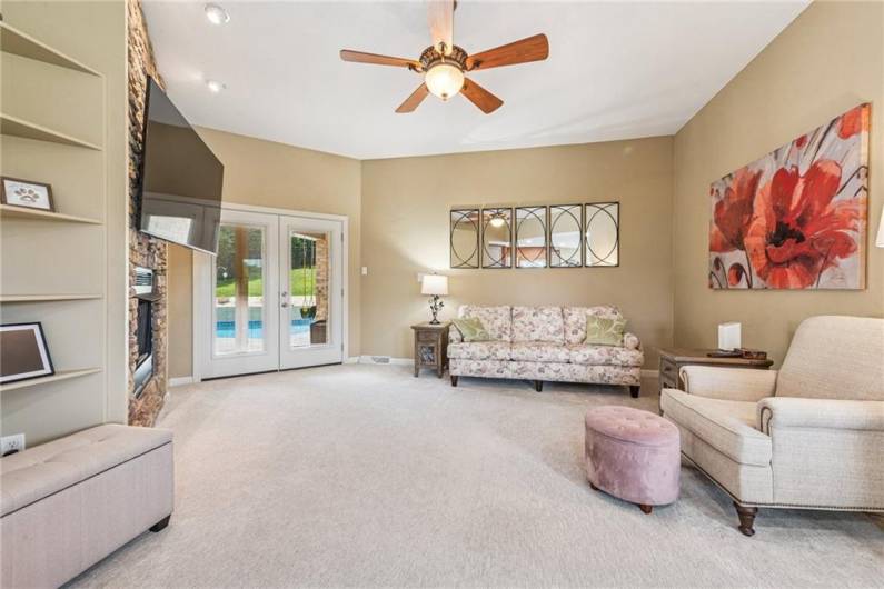 Sit cozy and watch tv enjoying the built in book cases or step out these double doors to the beautiful and private, built in pool!