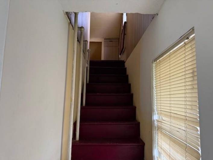 Stairs leading to attic from front bedroom
