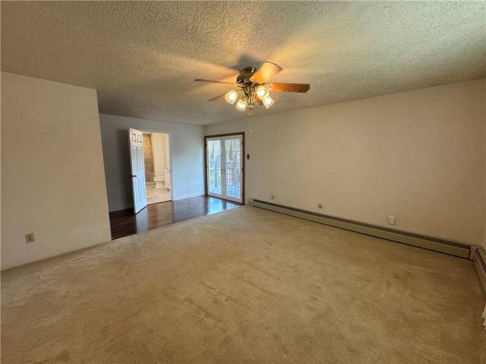 master bedroom w doors leading to deck