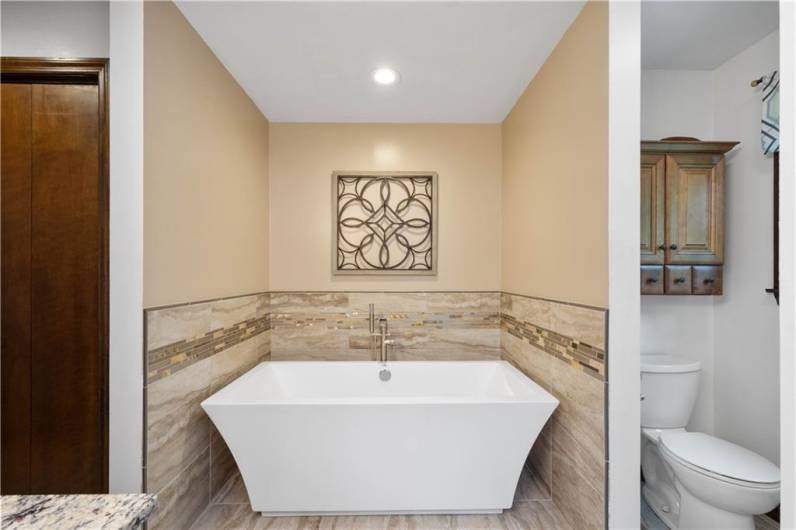 Newly added soaking tub with tile surround!