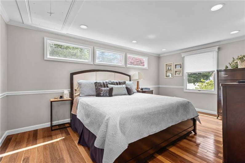 The master bedroom is filled with natural light from the large privacy windows. The Bellwood Brazilian teak hardwood floors are also found here.