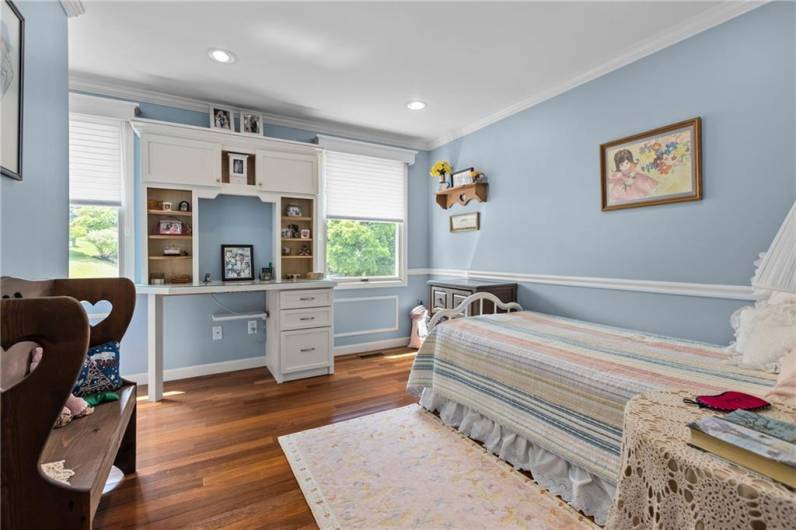 2nd bedroom has a built-in white deck with hutch and recessed lights.