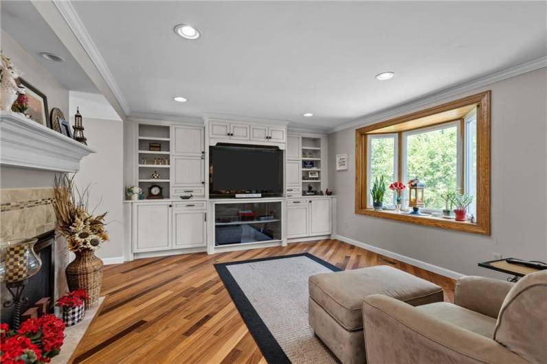 Built-in cabinetry and big screen tv stays with the house. A second bay window fills the room with natural light!