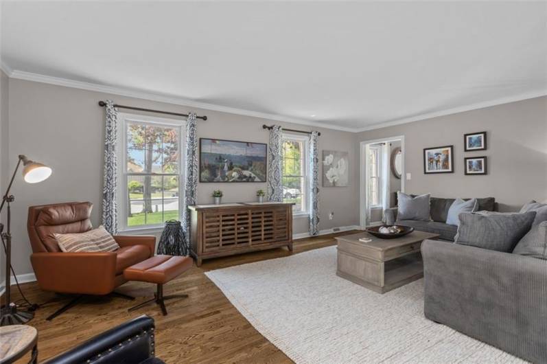 Refinished hardwoods floors and crown molding enhance the living room.