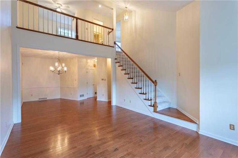 The hardwood floors in this formal living room make the room look bright and spacious. It also has a boxed window that lets in a lot of natural light.