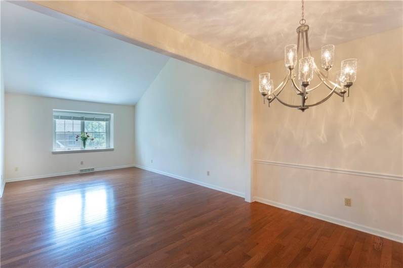 The formal dining room is on the main floor of this house and offers plenty of room for holiday meals and family get togethers. It has an eye-catching chandelier and beautiful hardwood floors.