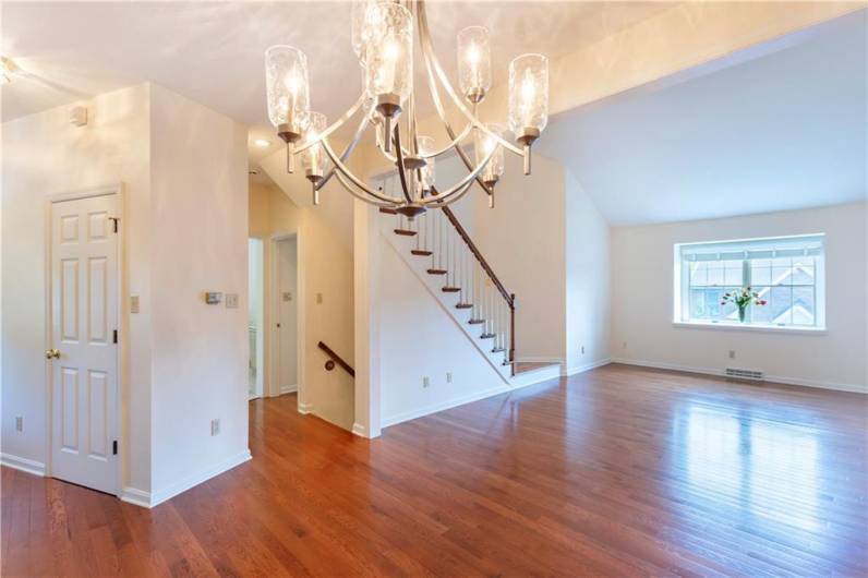 The hardwood floors in this formal living room make the room look bright and spacious. It also has a boxed window that lets in a lot of natural light.