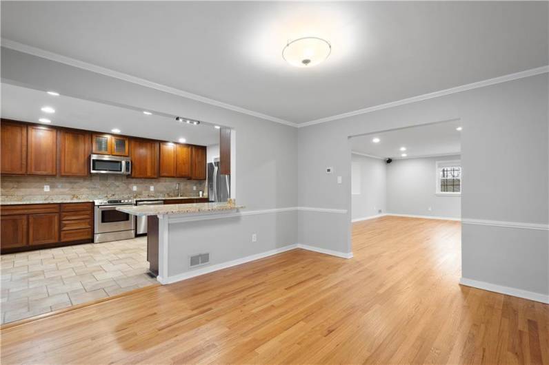 The dining room opens to the living room and kitchen with access to the sunroom.