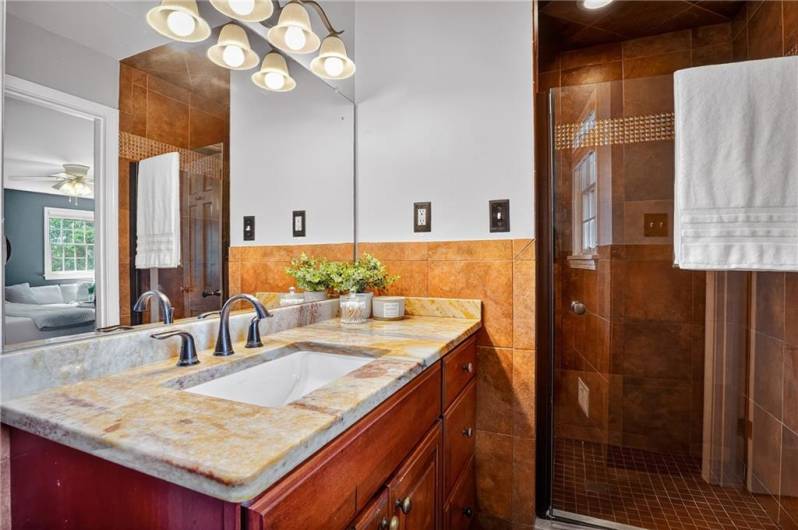 The primary bathroom features a large vanity, ample storage, and a soothing atmosphere—perfect for starting or ending your day in comfort and style.