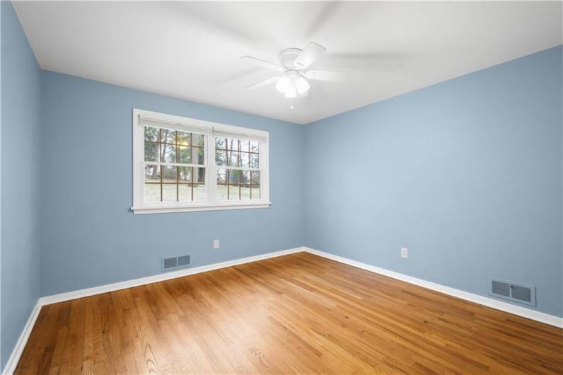 This bedroom is generously sized, offering plenty of space for a full furniture set, along with ample closet storage to keep things organized.