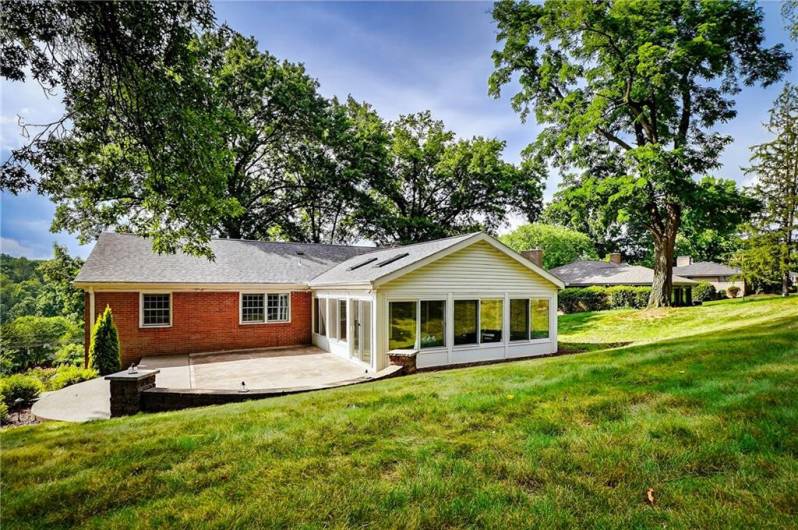 The backyard offers a peaceful retreat with mature trees creating a natural sense of privacy. It’s a quiet space to relax, play, or enjoy time outdoors surrounded by greenery.