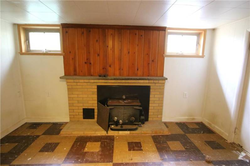 Close up of Wood Burning Stove in Brick Fireplace in Game Room