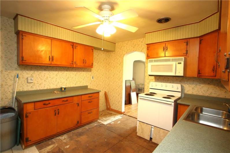 Spacious 12x11 Kitchen w/ Plenty of Wood Cabinetry including additional Countertop Workspace. Stove, Dishwasher & Microwave included. Plus Ceiling Fan Light!
