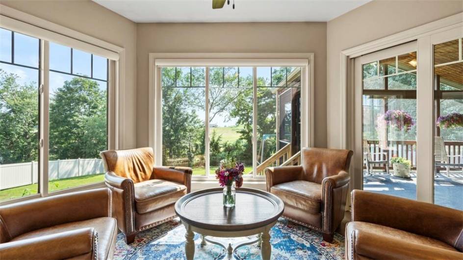 Floor to ceiling windows grace the lovely breakfast nook.  Access to the large covered porch