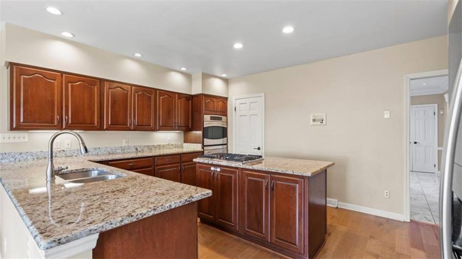 Generously sized kitchen with quality cabinets , granite counters, stainless appliances and LVP floors