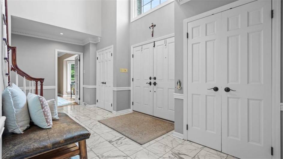 Generous entry closets flank the gracious entry hall
