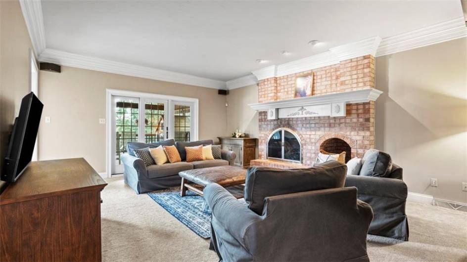 Elaborate moldings and statement fireplace in the family room
