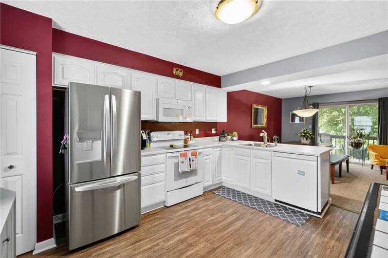 The kitchen features newer LVP flooring and appliances (refrigerator is brand new)...and has a nice pantry right to the left!