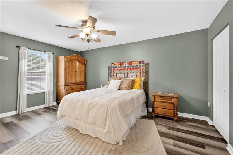 The primary bedroom is quite large at 16 x 11 and features a lovely ceiling fan, new LVP flooring and double closets!