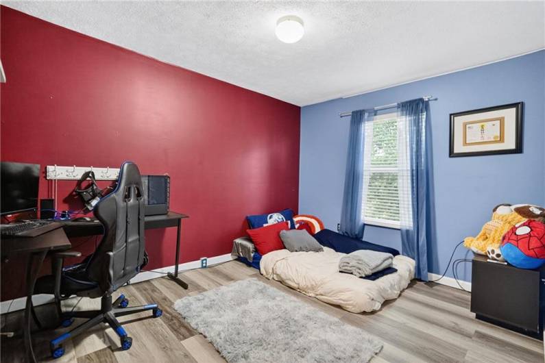 Bedroom 2 features new LVP flooring and measures approximately 12 x 9.
