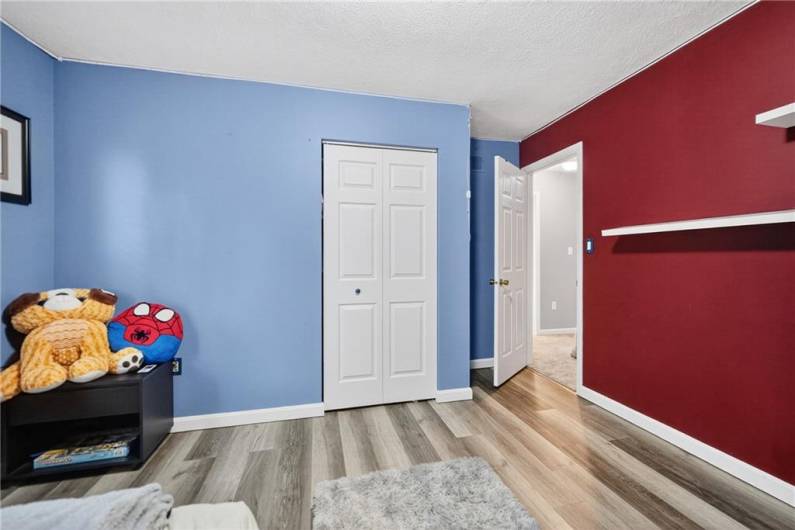 Bedroom 2 with its new LVP flooring and ample closet.
