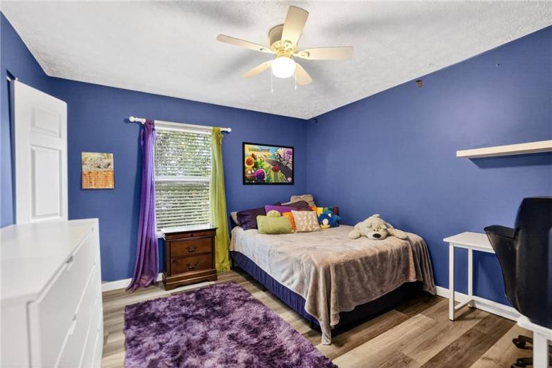 Bedroom 3 is quite spacious at 13 x 12 and features a ceiling fan and new LVP flooring as well as an ample closet!