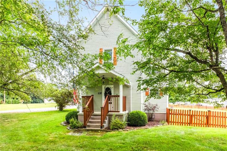 Straight on Front view w/ lovely front porch and mature landscaping~