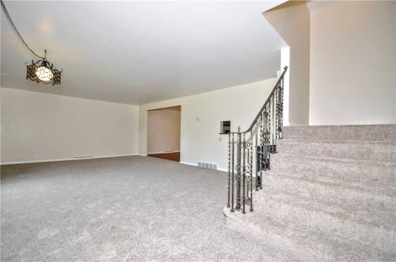 Another View of Large Living Room w/ Wide Staircase to 2nd Floor