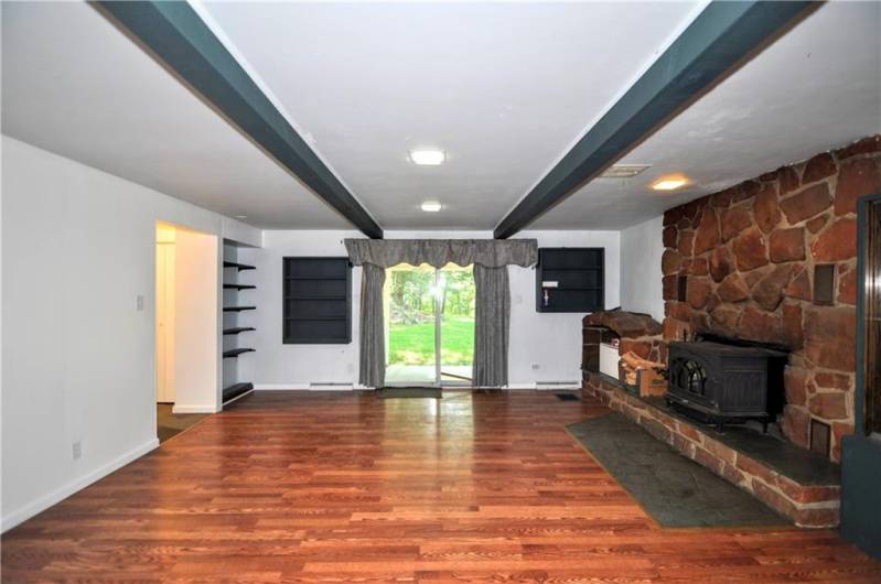 Newer Flooring in 1st Floor 20x17 Family Room featuring Stone Wood Burning Fireplace & Sliding Glass Door to Backyard