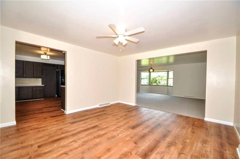 Separate 14x14 Formal Dining Room w/ Ceiling Fan Light & Wide Opening into both Kitchen & Living Room. Newer Flooring & Freshly Painted